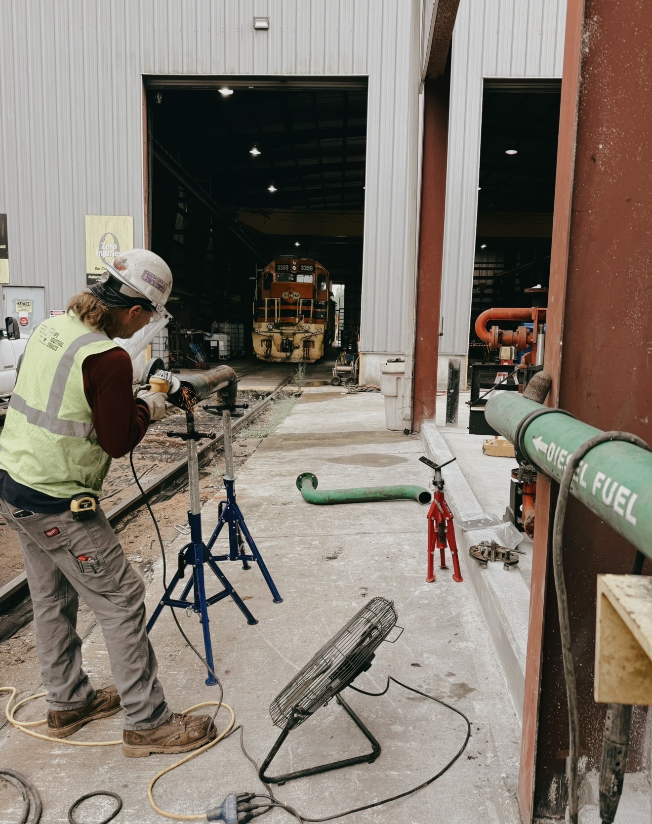 Walker Welding field crew grinding pipe at an industrial rail site
