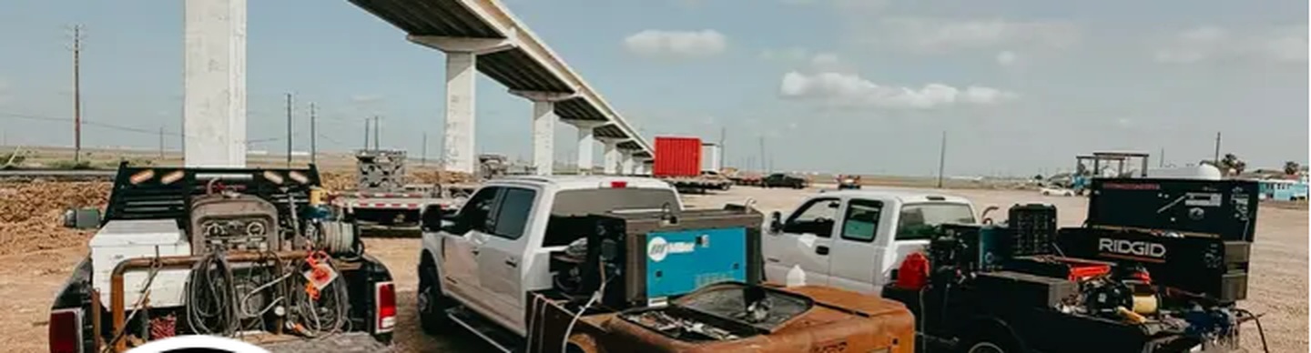 Walker Welding trucks lined up on an industrial job site